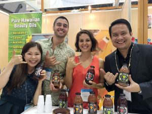 Shaka Tea owners Harrison Rice and Bella Hat the Tokyo Gift Show with DBEDT director Luis Salaveria and their translator