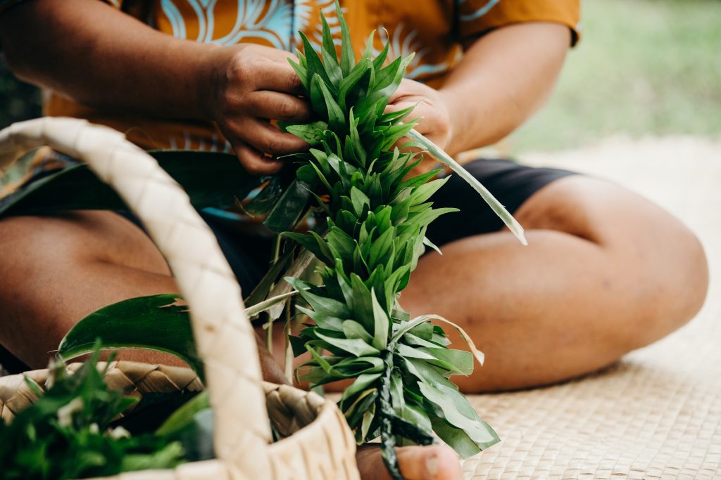 Person making Hawaiian Lei