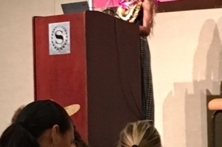 A female speaker at a podium