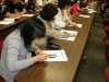 Students sitting at desks looking at handouts