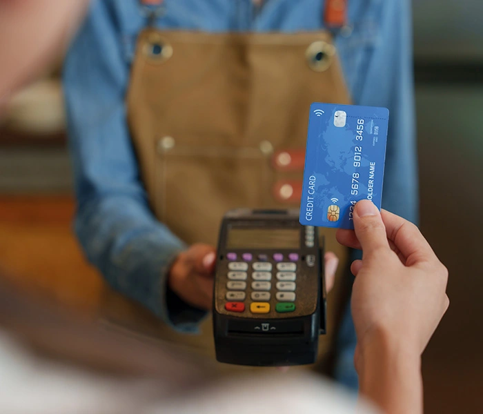 A customer holding a credit card in their hand